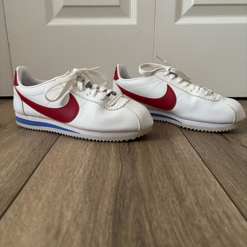 Nike Women's White Sneakers with Red Swoosh and Blue Accent